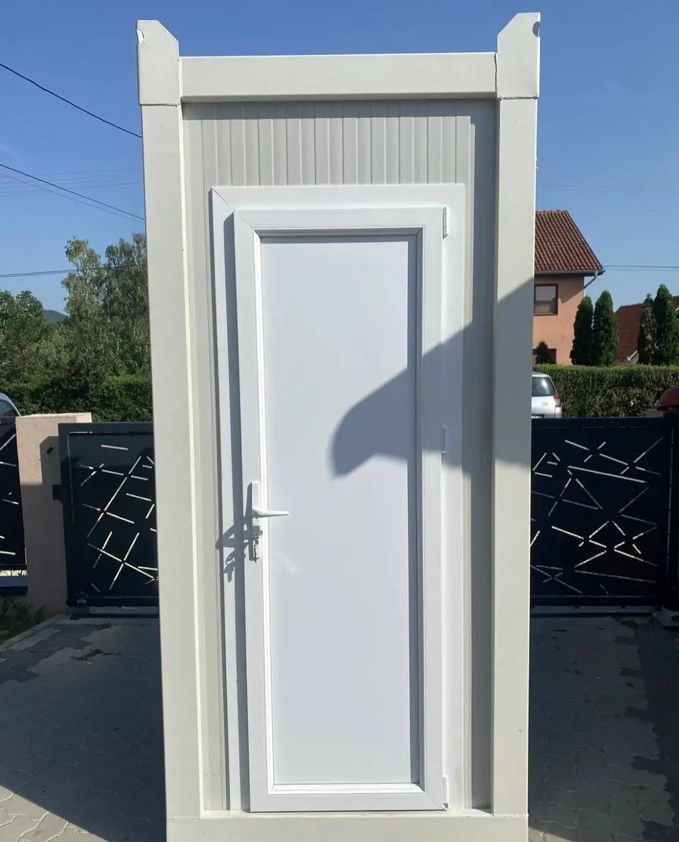Front door of a white VIP restroom cabin